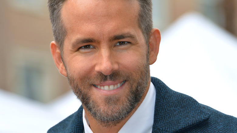 Ryan Reynolds smiling at a Hollywood Walk of Fame event 