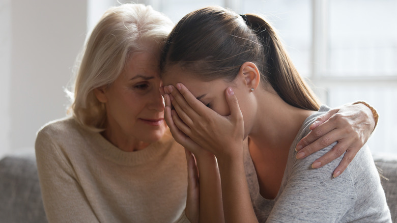 Older woman comforting younger woman