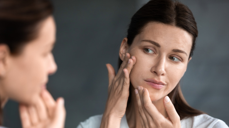 Woman looking at acne