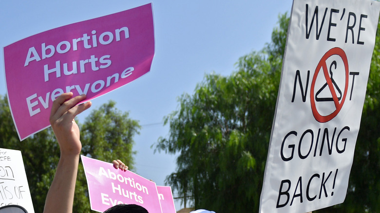 Protestors holding up anti-abortion signs