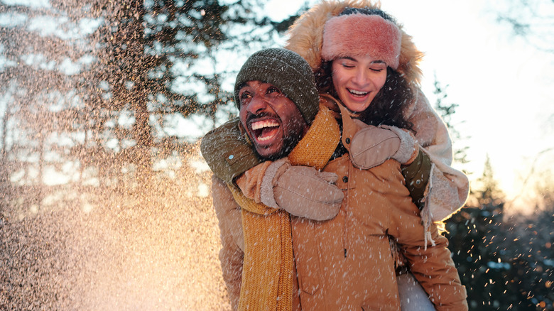 couple playing in the snow