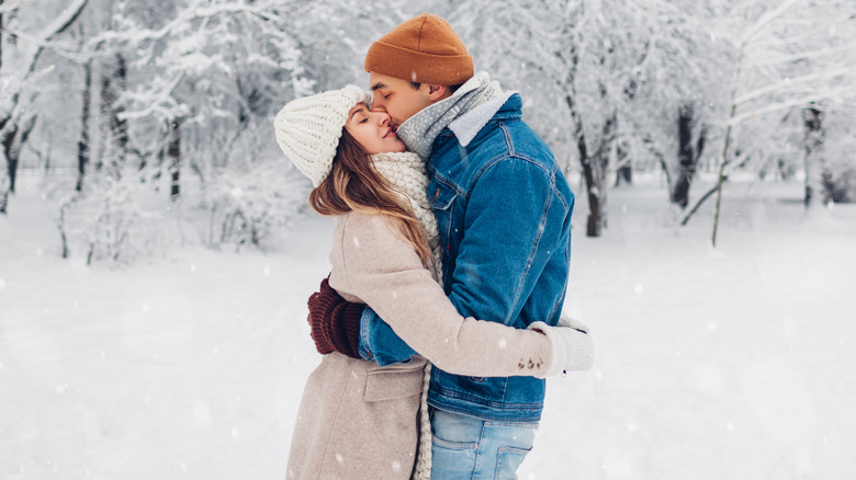 couple kissing and hugging in the snow