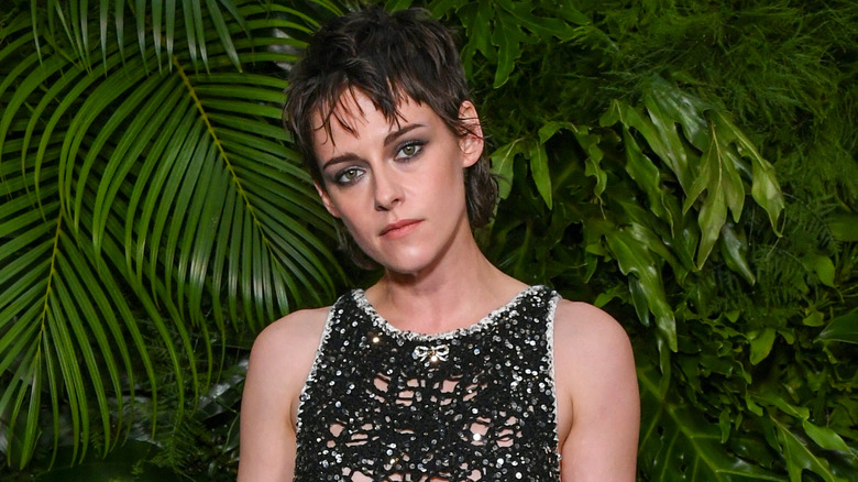 Kristen Stewart posing at a Chanel event 