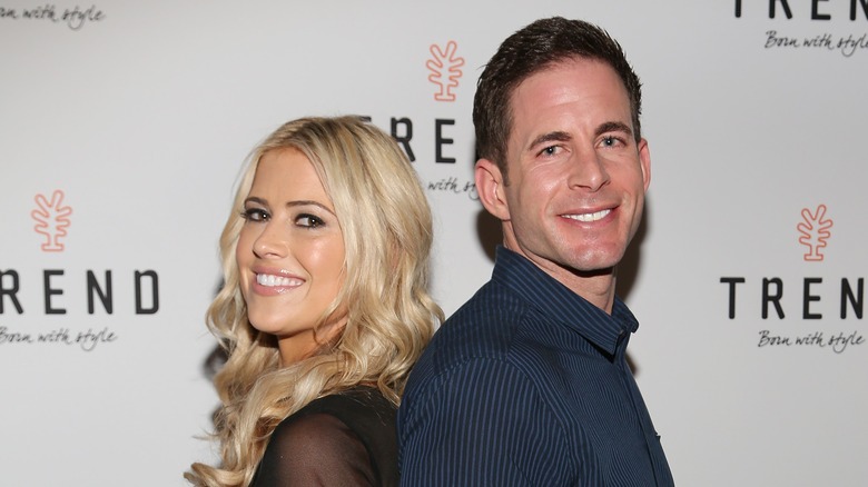 Tarek El Moussa and Christina Haack pose back to back at an event