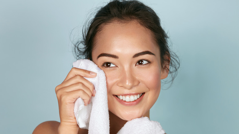 Woman using a soft cloth to take off her makeup