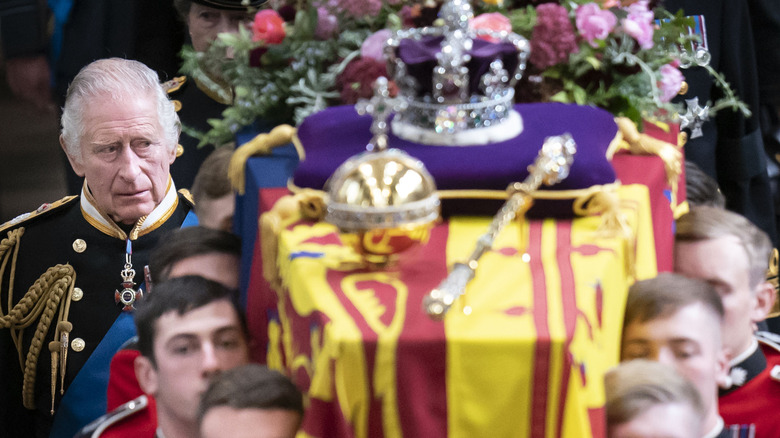 King Charles walking beside Queen Elizabeth's coffin