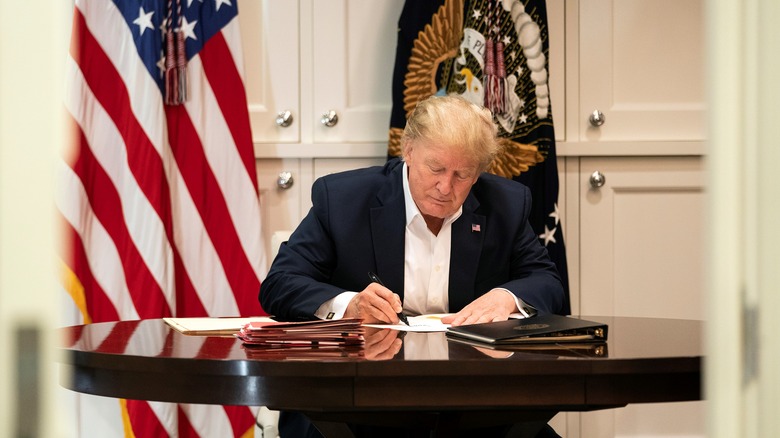 Donald Trump sitting at a desk at Walter Reed