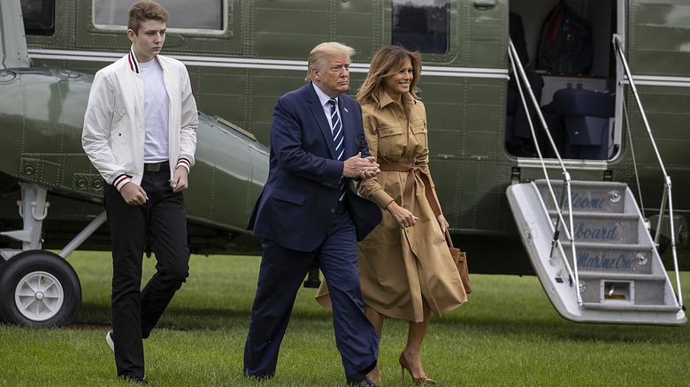 Donald, Barron and Melania Trump exit plane