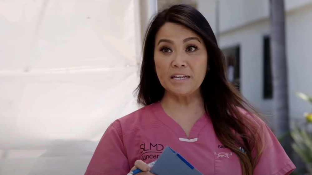 Dr. Pimple Popper holding clipboard