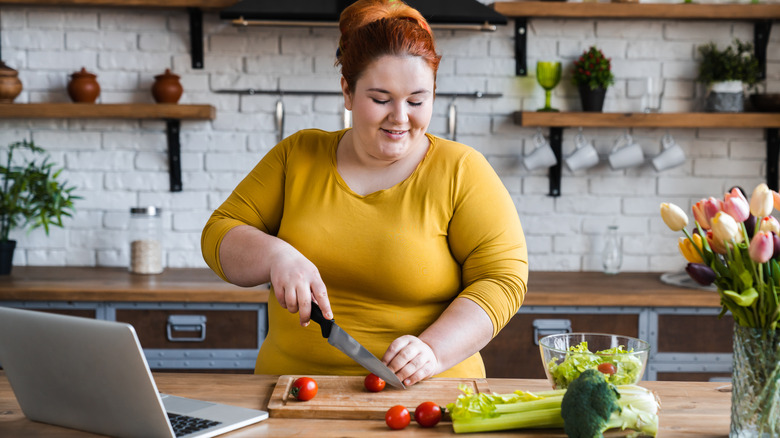 woman cutting cherry tomatoes