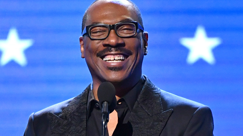 Eddie Murphy on stage accepting award 