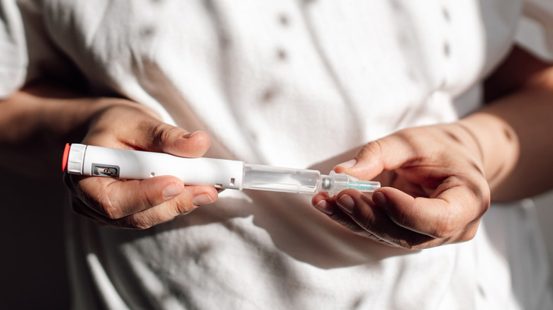 Person preparing to inject semaglutide