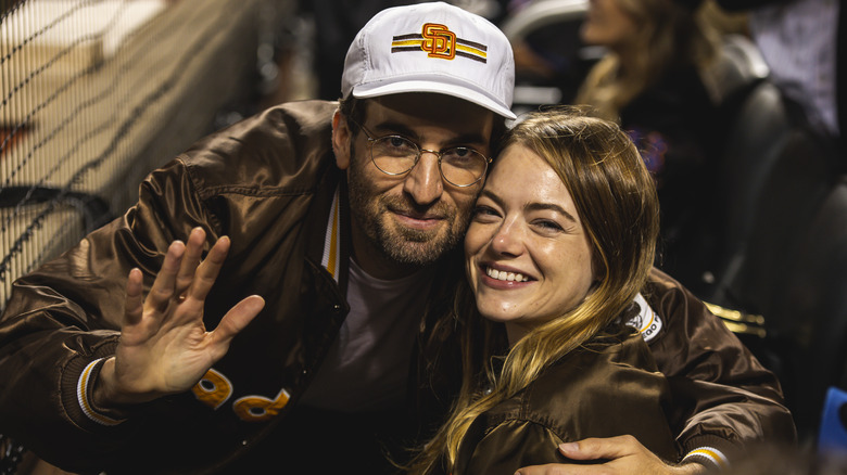 Dave McCary hugs smiling Emma Stone