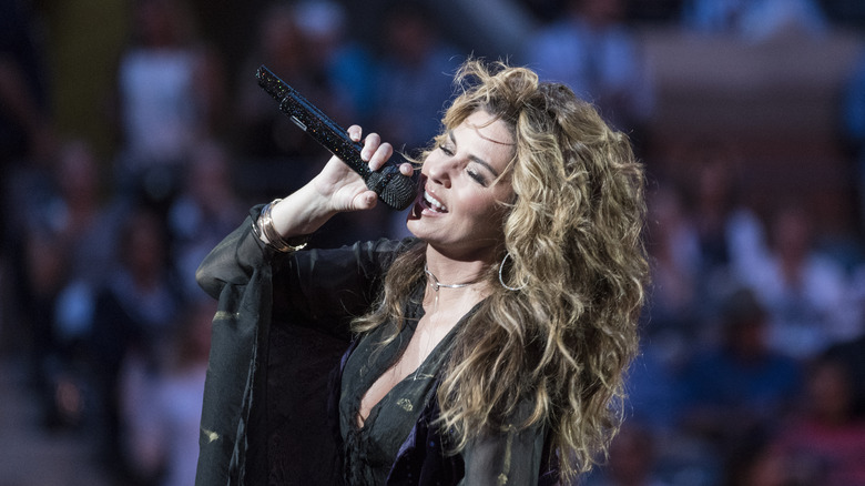 Shania Twain singing into a microphone