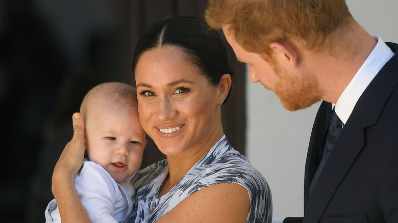 Meghan and Harry pose with Archie
