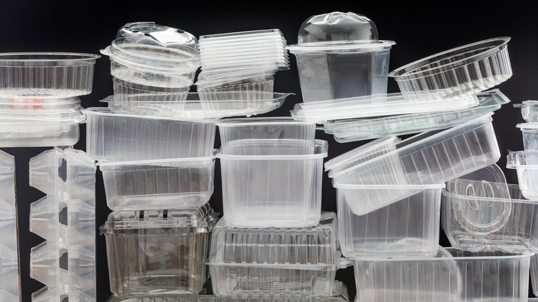 stack of empty plastic food containers