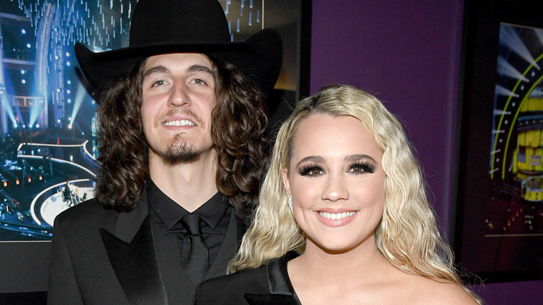 Gabby Barrett and husband smiling on the red carpet