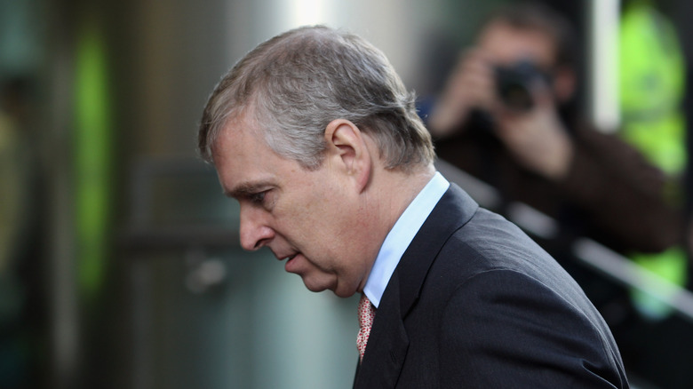 Prince Andrew with his head bowed down