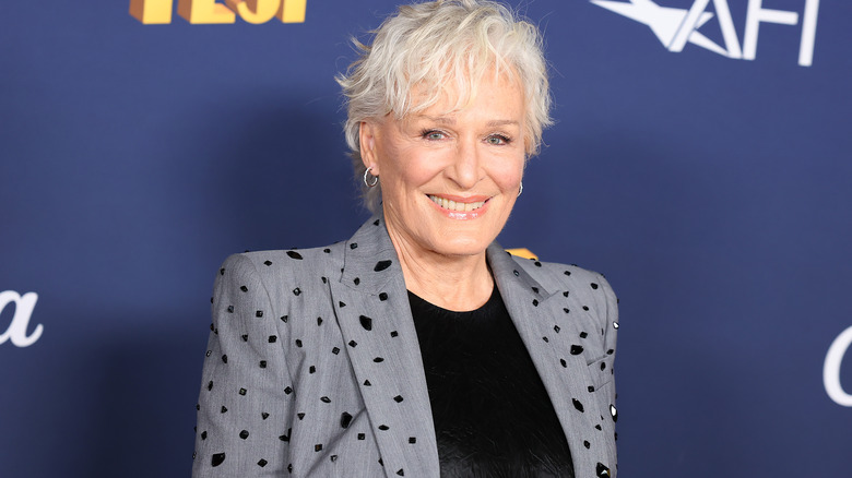 Glenn Close smiling gray suit with black gems