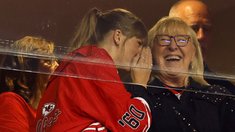 Taylor Swift whispering to Donna Kelce