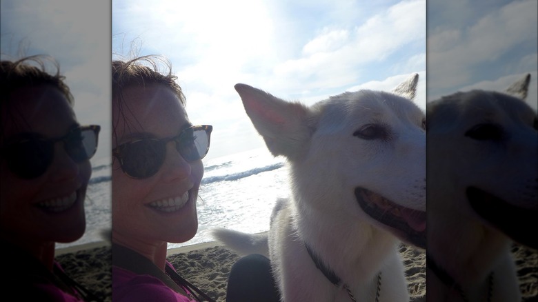 Ashley Williams in a beach selfie with her late dog Chi