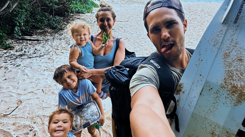 Alexa and Carlos with their kids on a beach 