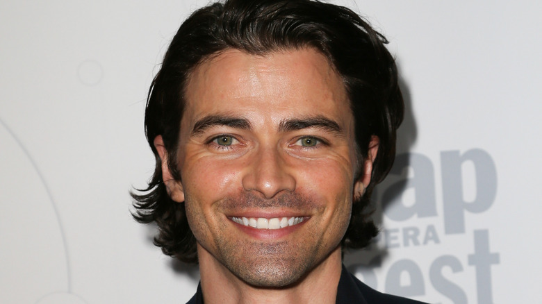 Matt Cohen with longer hair smiling