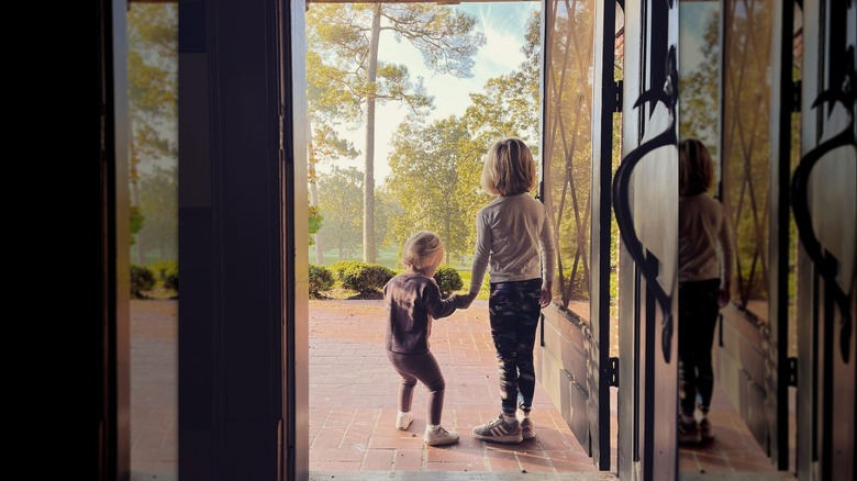 A rear view of the Napier children in a doorway 