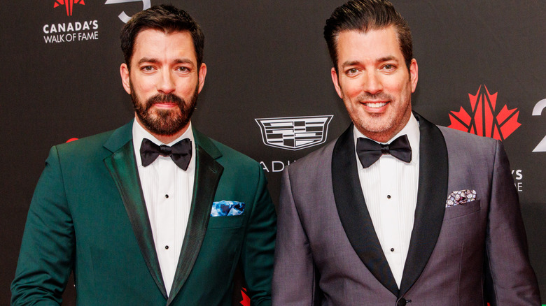 Drew and Jonathan Scott smile side by side