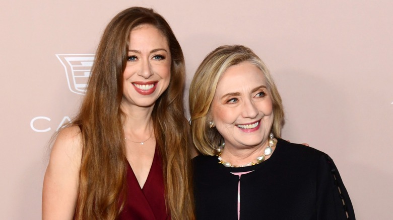 Chelsea and Hilary Clinton posing together at an event