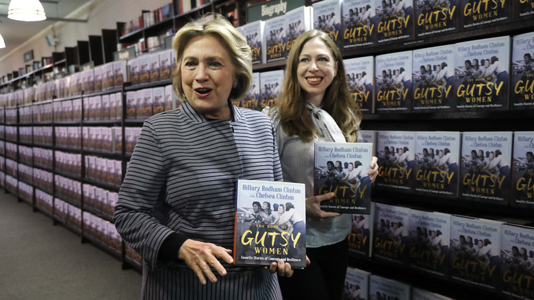 Hillary and Chelsea Clinton holding books