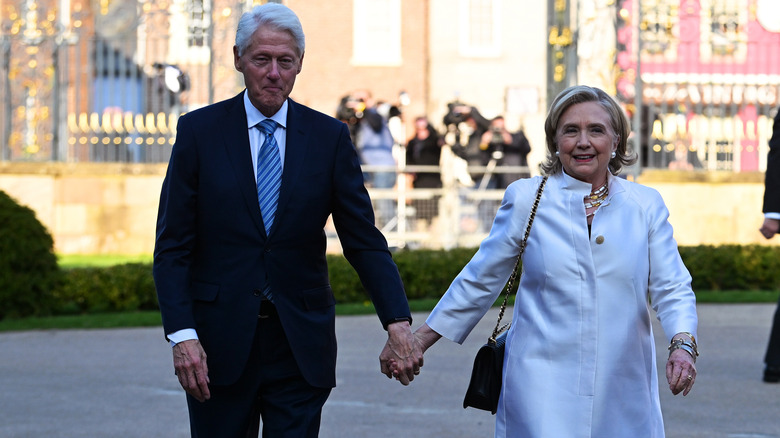 Hillary and Bill Clinton holding hands