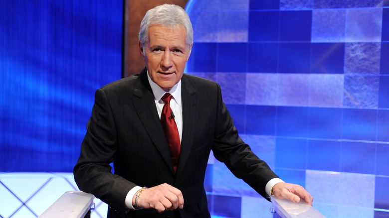 Alex Trebek posing on Jeopardy! set