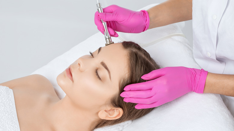 Woman having microdermabrasion treatment