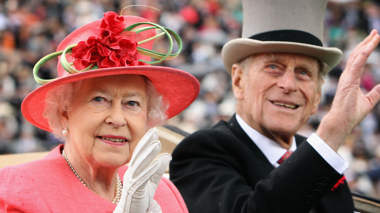 Queen Elizabeth and Prince Philip waving