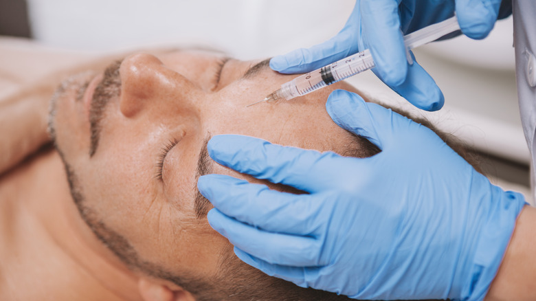 Man receiving face fillers