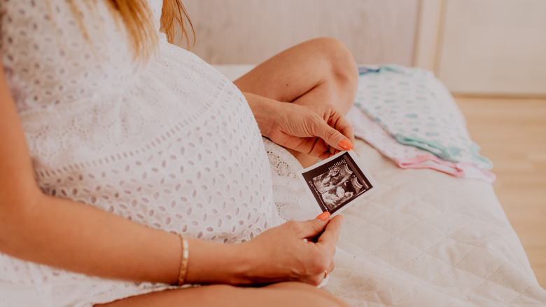 Pregnant woman looking at her sonography