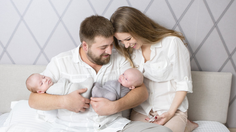 couple holding twin babies