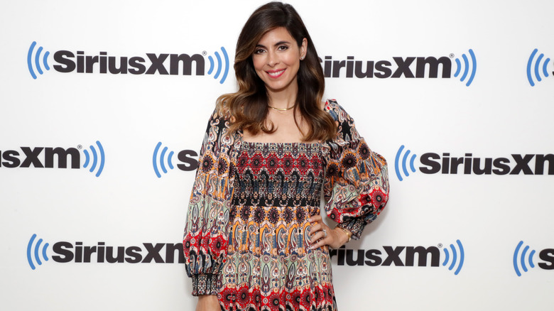 Jamie-Lynn Sigler in a patterned dress and smile