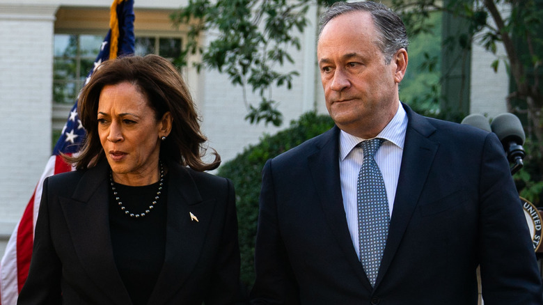 Kamala Harris and Doug Emhoff looking to the side outdoors