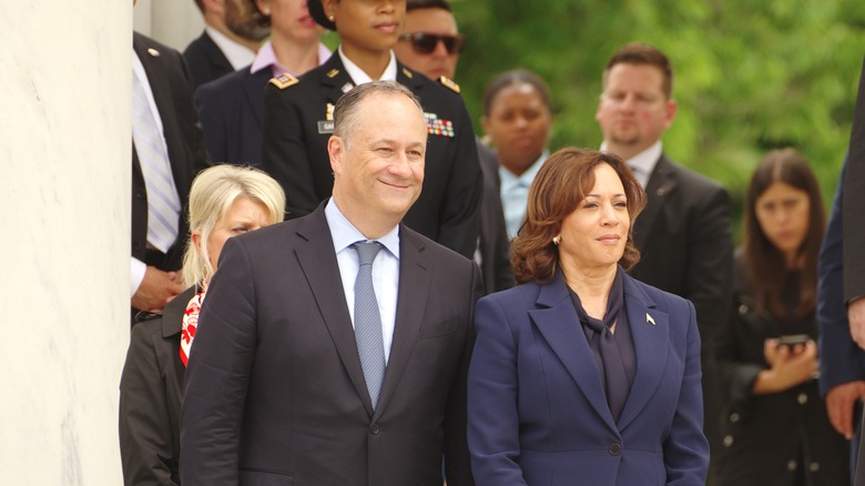 Kamala Harris and Doug Emhoff smiling at a Memorial Day ceremony at Arlington National Cemetery