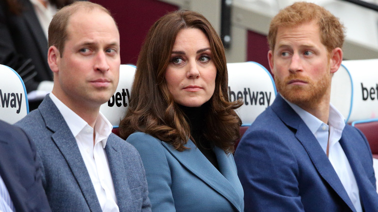 Princess Catherine and Prince Harry looking serious