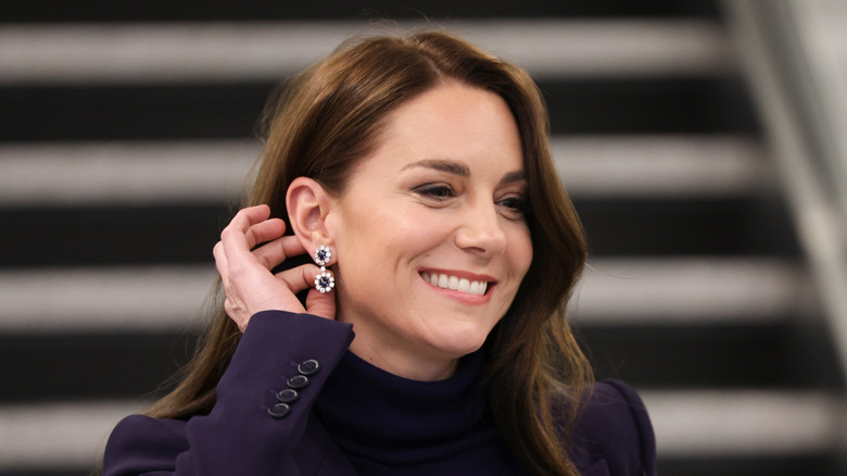 Kate Middleton smiling and showing off Princess Diana's earrings 