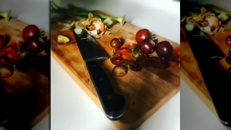 cutting board with vegetables and a knife