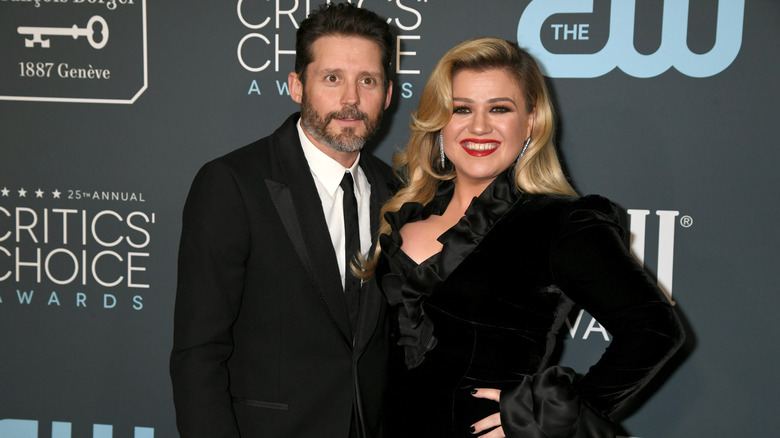 Brandon Blackstock and Kelly Clarkson smiling and posing together in black