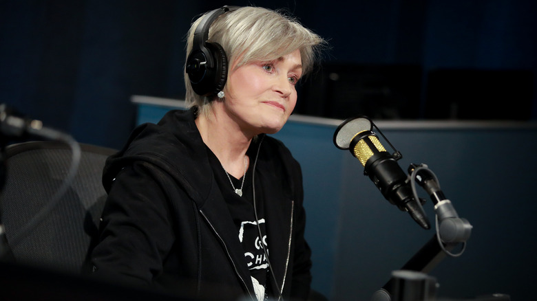 Sharon Osbourne sitting in front of microphone during radio interview