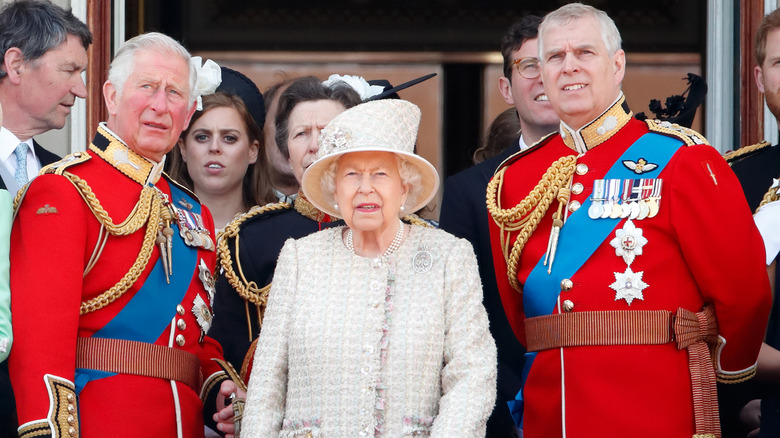 King Charles III, Queen Elizabeth II, and Prince Charles looking in the distance 