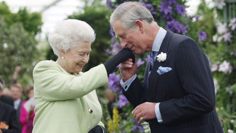 Charles kissing the queen's hand 