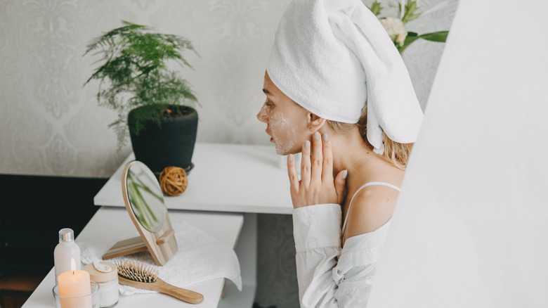 A woman performing skin care.