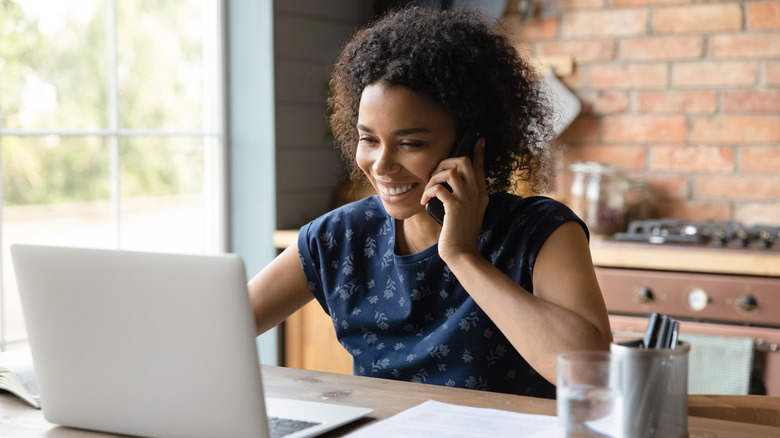 A woman on the phone in her office.